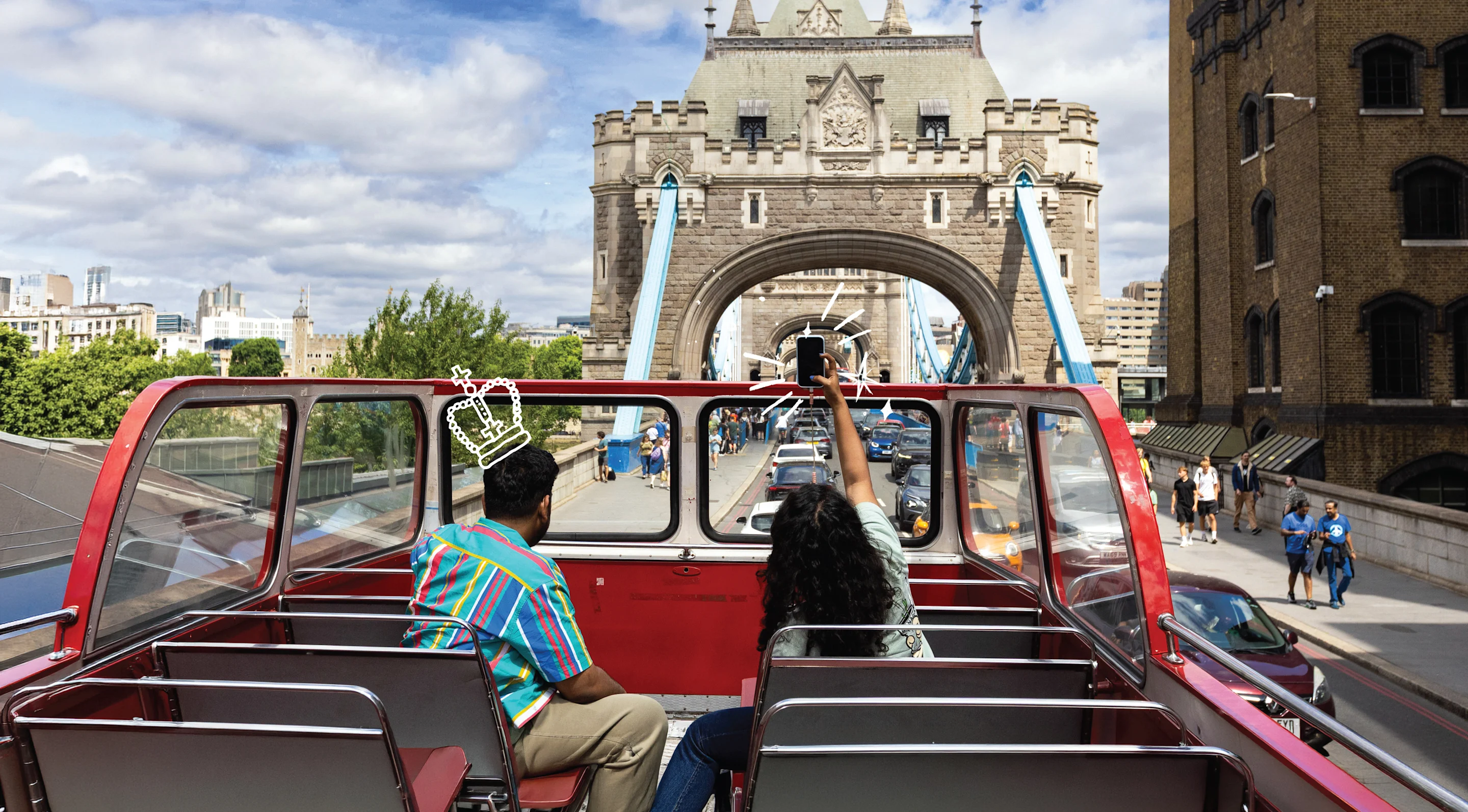 Couple looking at Tower Bridge from open top sightseeing bus