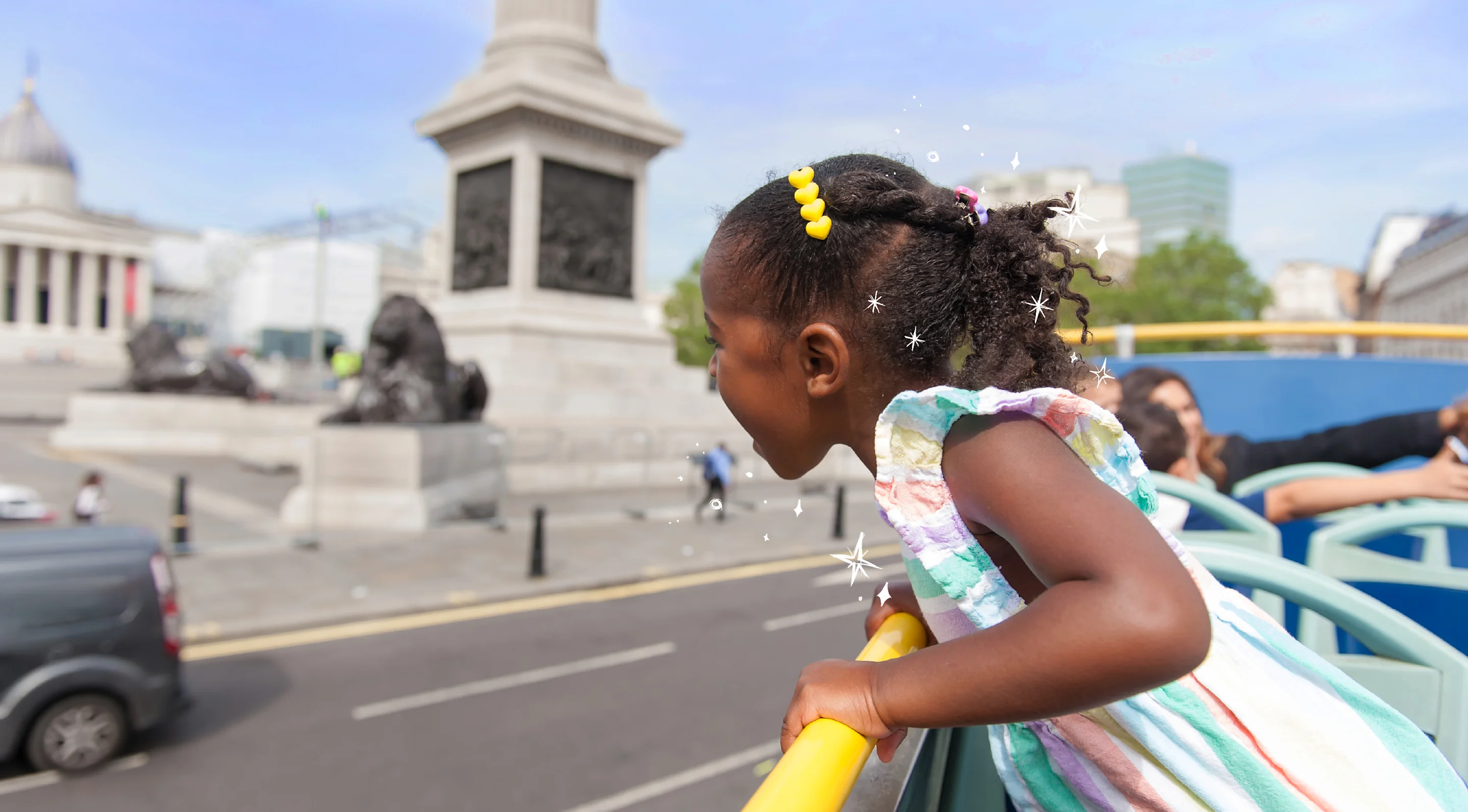 Child looking at sights from open top sightseeing bus