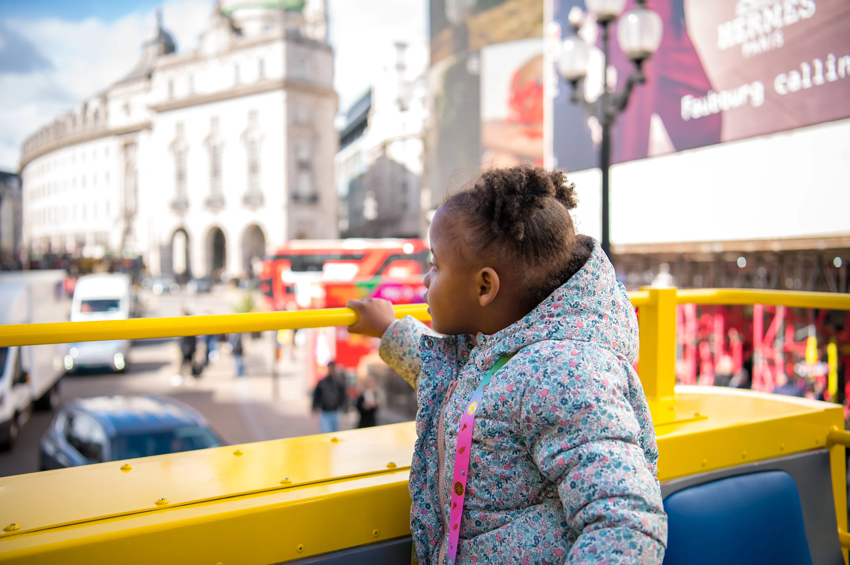 Child looking at London sights from Open Top Bus