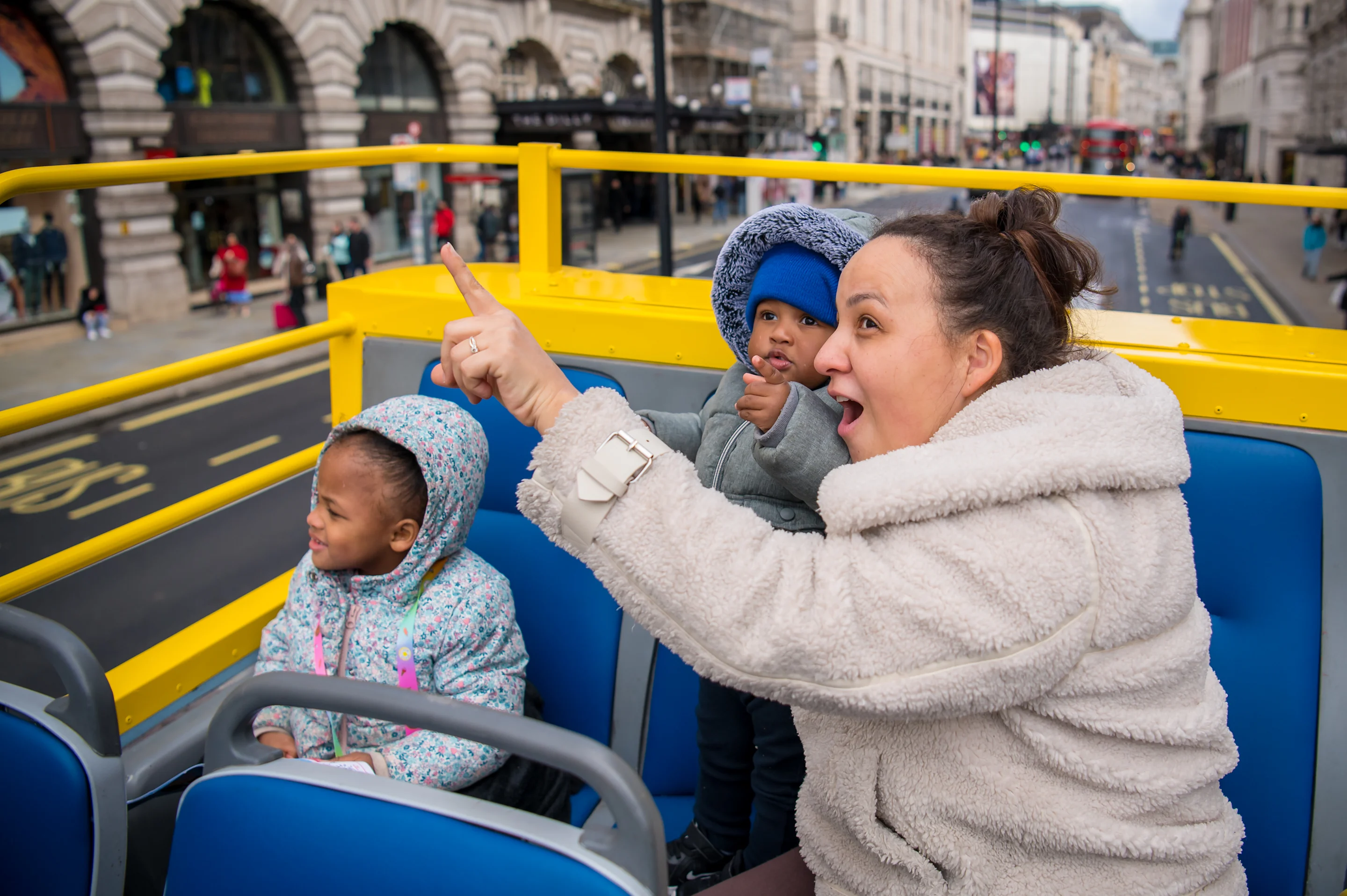 Woman with two kids on top of Open Top Bus