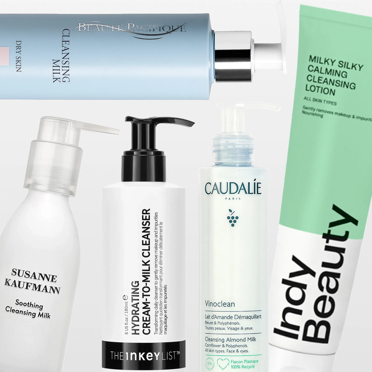 Useita ihonhoitotuotteita puhdistusmaidon muodossa merkeiltä Susanne Kaufmann, The Inkey List, Caudalie ja Bubble skincare, pumppupulloissa ja tuubeissa vaaleaa taustaa vasten. Näkyvä teksti sisältää “Soothing Cleansing Milk”, “Oat Cleansing Balm”, “Vinoclean Cleansing Almond Milk” ja “Milky Silky Calming Cleansing Lotion”.