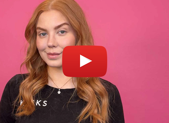 Jente med krøllete hår med cerise bakgrunn. Rød "YouTube"-knapp i midten.