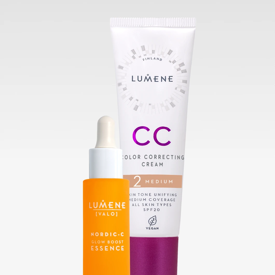 Nærbilde av to Lumene hudpleie- og makeup-produkter mot en lys bakgrunn: en oransje glassflaske med Lumene Nordic-C Glow Boost Essence og en hvit tube Lumene CC Color Correcting Cream med lilla og beige detaljer. Produktene ligger diagonalt for å skape et friskt, glød-fokusert uttrykk.