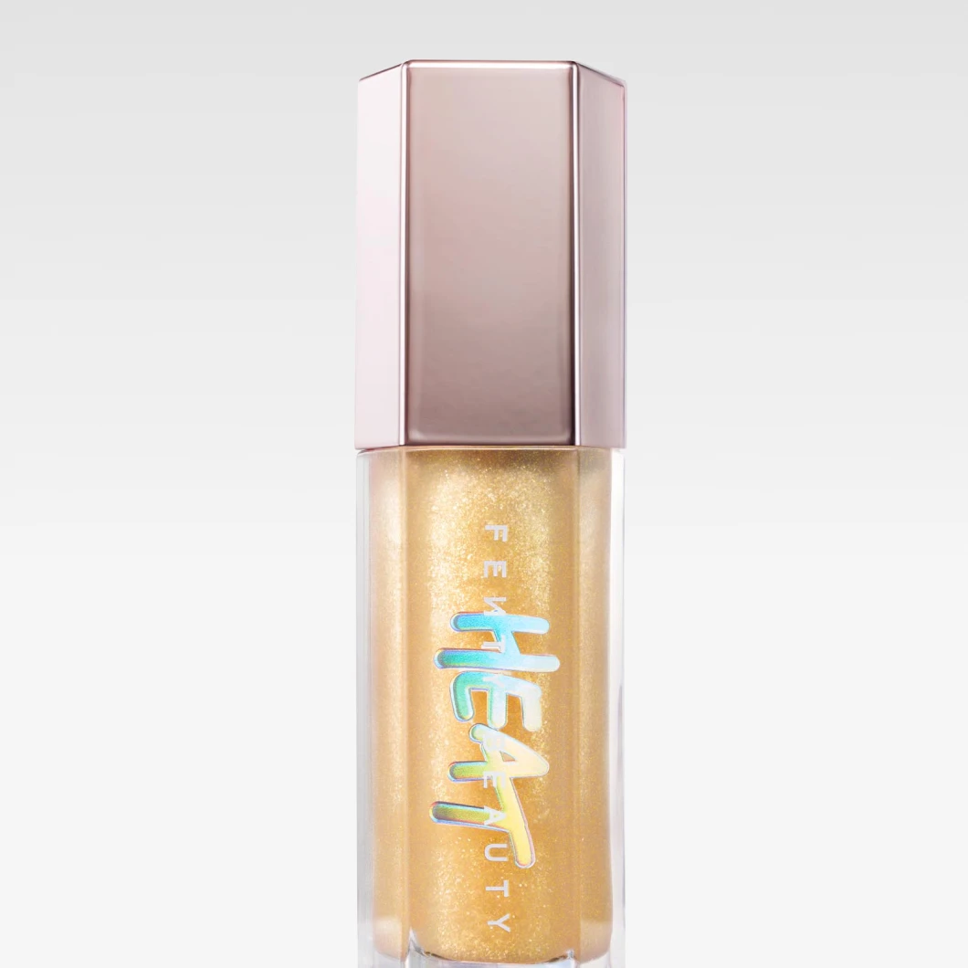 "Fenty Beauty Gloss Bomb Heat lipgloss i guldnyans – plumping glans för fylligare och glänsande läppar."