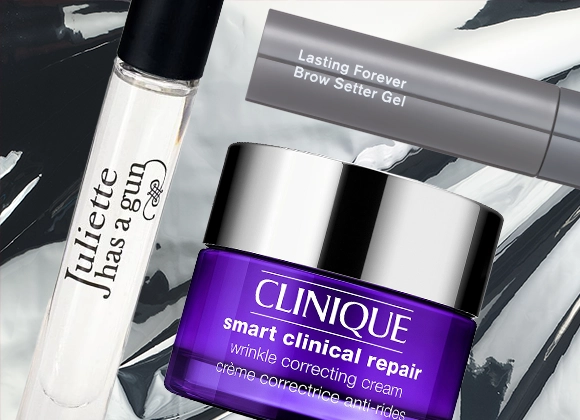 Kuva, joka näyttää kolme kauneustuotetta: valkoinen pullo Juliette Has a Gun hajuvettä, harmaa tuubi Lasting Forever Brow Setter Gel, ja violetti purkki Clinique Smart Clinical Repair Wrinkle Correcting Cream. Tausta on valkoinen mustilla yksityiskohdilla.