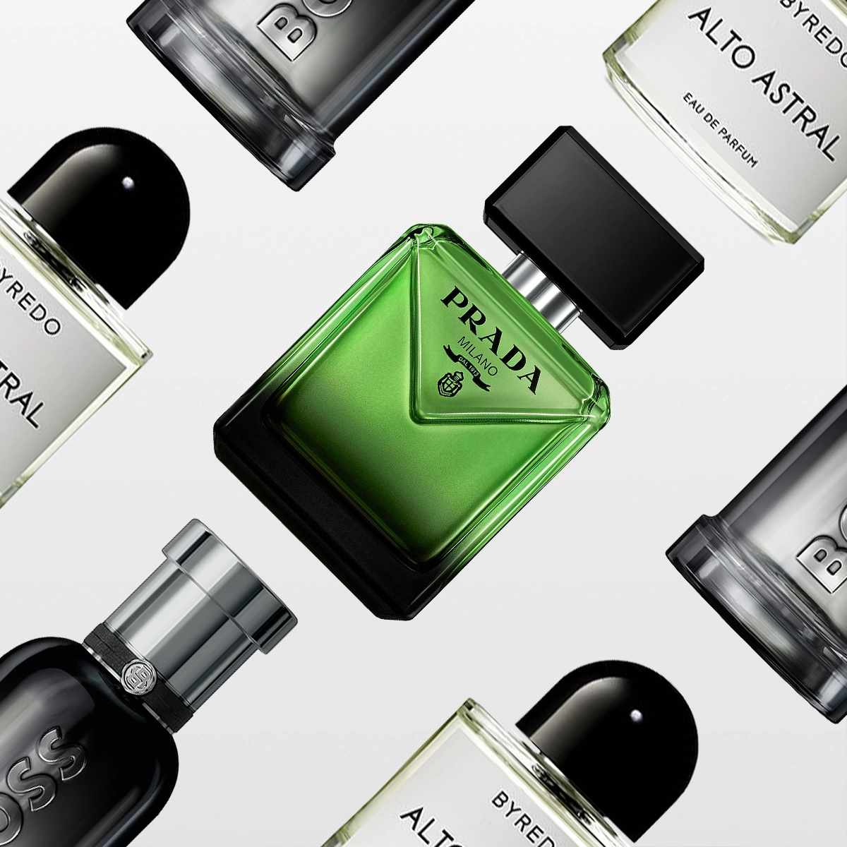 Et elegant bilde med flere herreparfymer mot en lys bakgrunn: en grønn, firkantet flaske fra Prada, svarte flasker fra Hugo Boss og gjennomsiktige flasker med svart kork fra Byredo Alto Astral. Perfekt som farsdagsgave eller gavetips til menn.