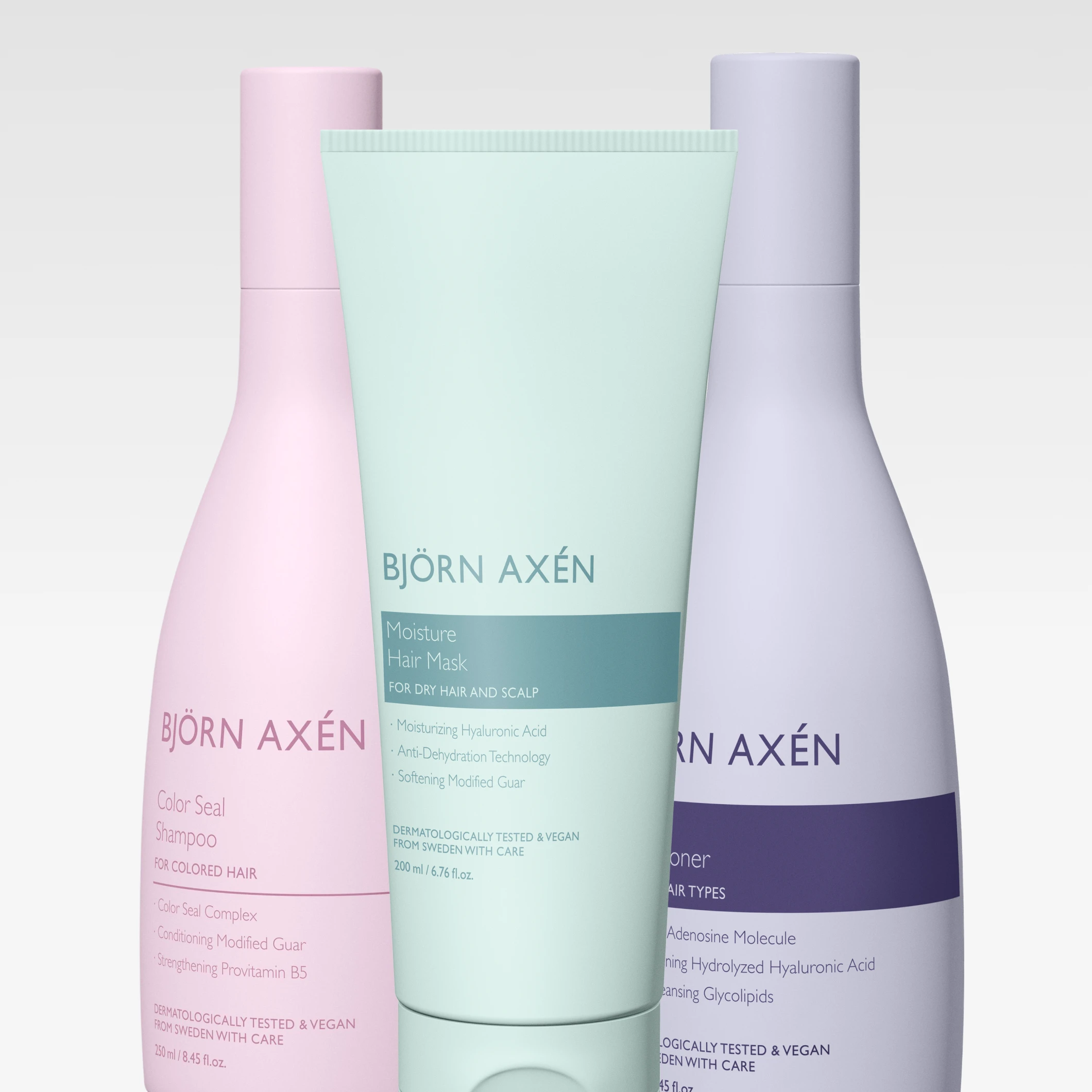 Hårvårdsprodukter från Björn Axén: “Color Seal Shampoo”, “Moisture Hair Mask” och “Scalp Conditioner” i pastellfärgade flaskor och tub. På förpackningarna syns även texter som “FOR COLORED HAIR”, “FOR DRY HAIR AND SCALP”, “DERMATOLOGICALLY TESTED & VEGAN” och “FROM SWEDEN WITH CARE”.