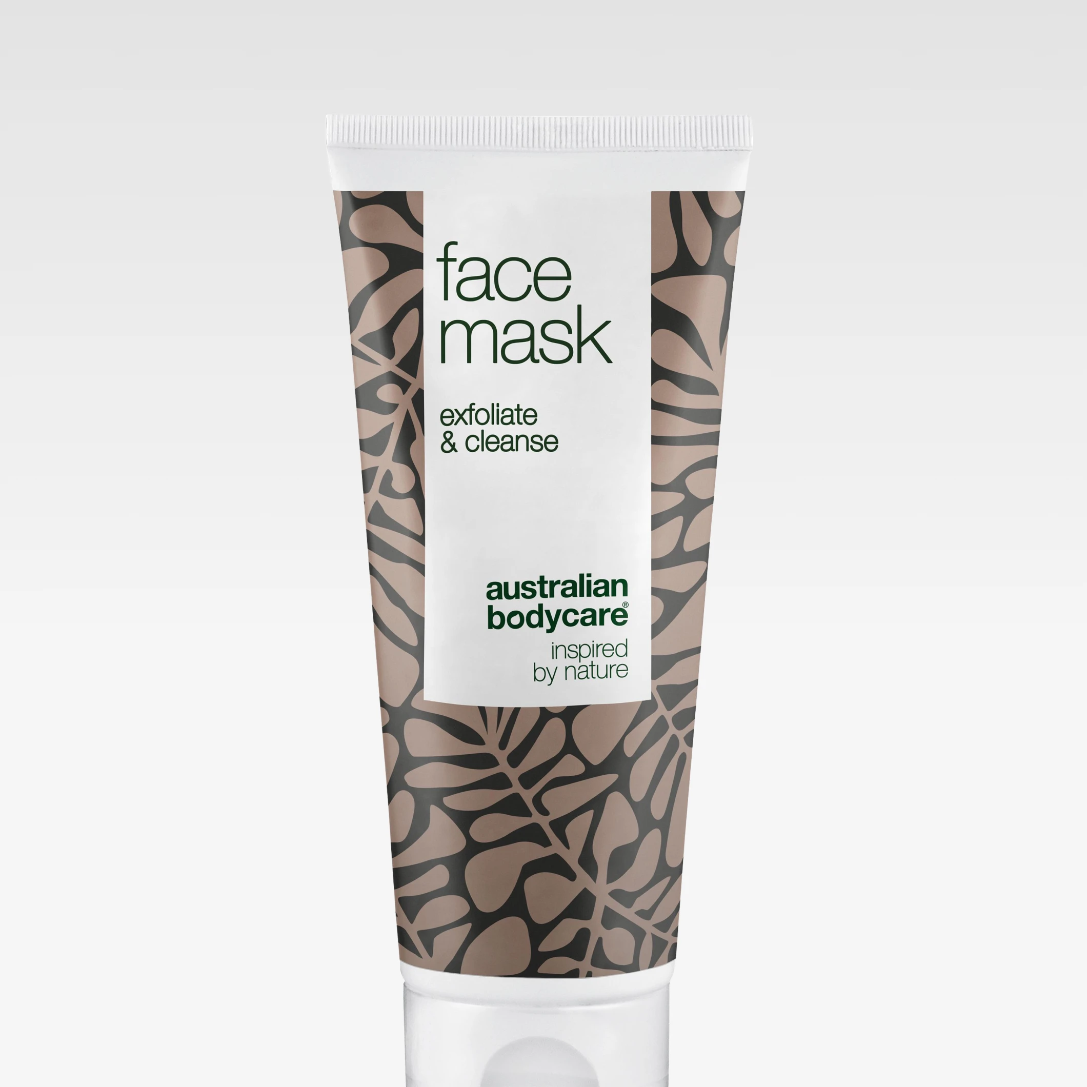 Förpackning av Australian Bodycare Face Mask i tub med texten ”face mask exfoliate & cleanse” på vit och beige tub med bladliknande mönster mot ljus bakgrund.