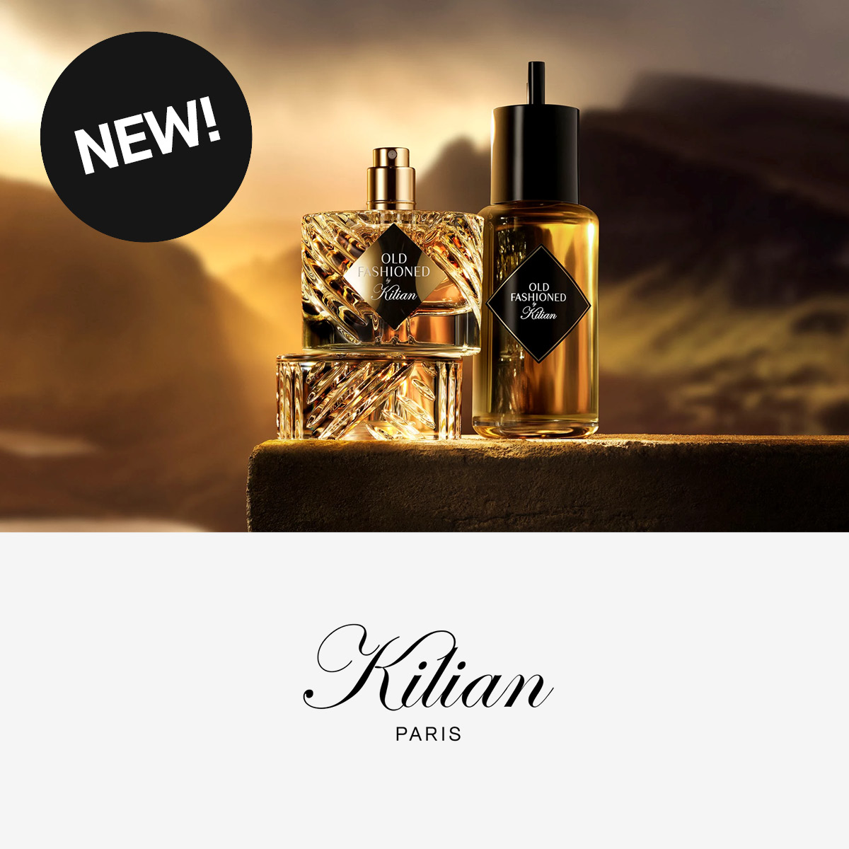 Kilian Parisin uusi tuoksu 'Old Fashioned' esillä kauniissa lasipulloissa, taustalla sumuinen maisema.