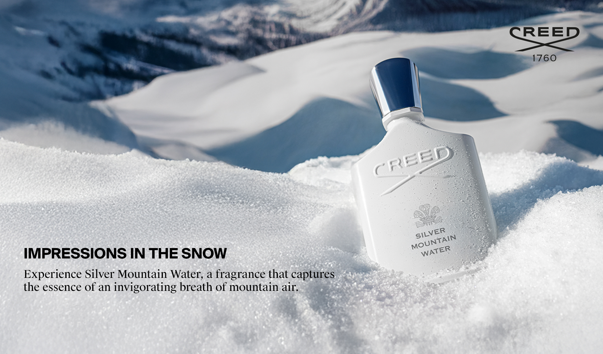 Creed Silver Mountain Water-parfymflaska i snöigt bergslandskap.