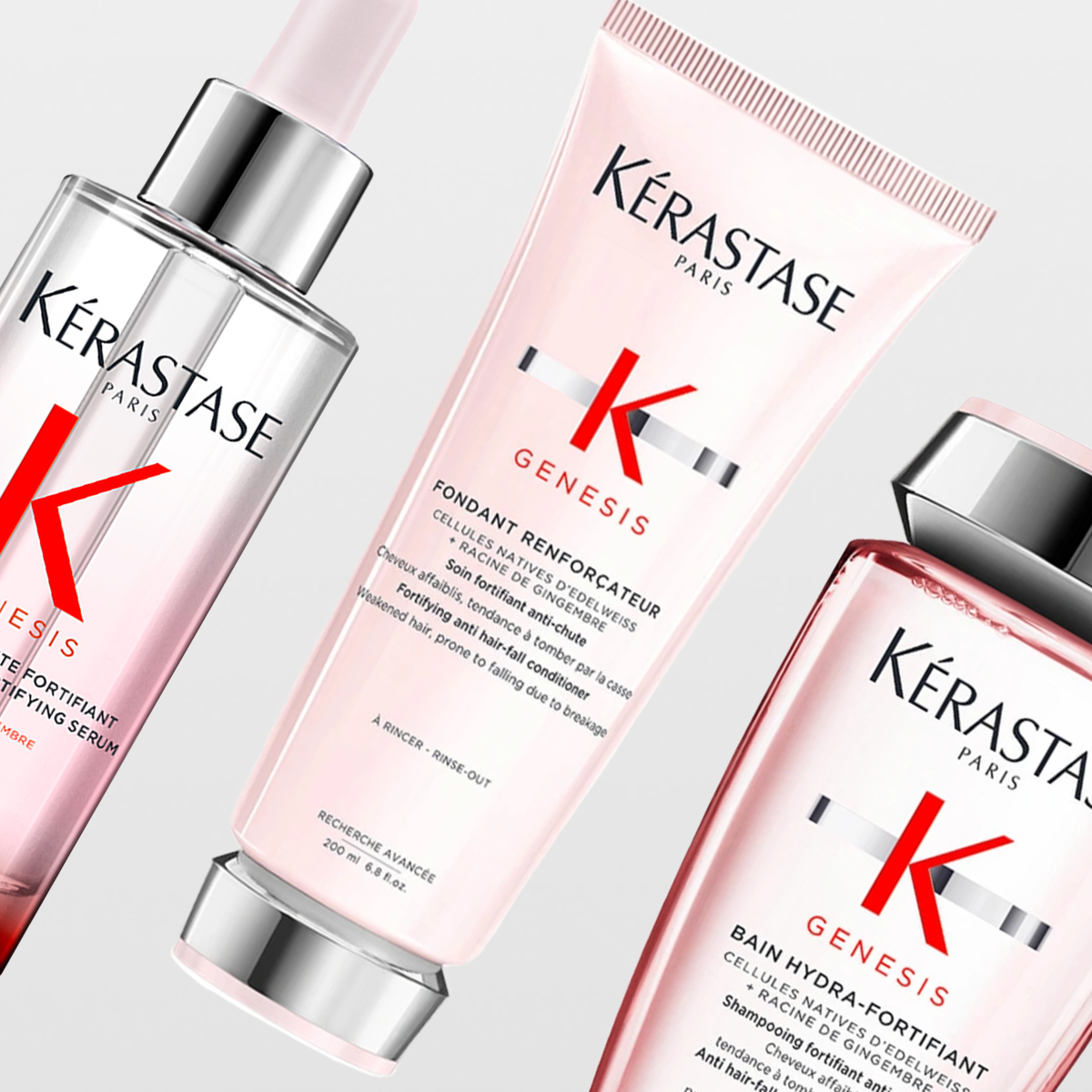 Produktbilde med tre hårpleieprodukter fra Kérastase Paris Genesis-serien mot en lys bakgrunn. Viser et serum, en balsam og en sjampo i rosa og sølvfarger. For styrkende og pleiende h�årpleie.