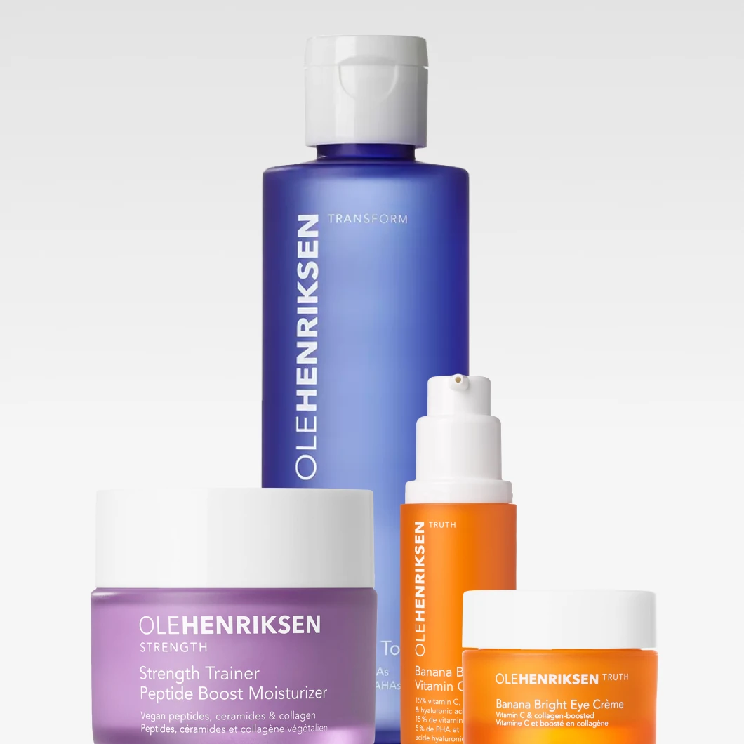 Fyra hudvårdsprodukter från Ole Henriksen mot ljus bakgrund: en blå flaska med vit kork märkt “OLEHENRIKSEN Transform”, en lila burk märkt “Strength Trainer Peptide Boost Moisturizer”, en orange pumpflaska märkt “Banana Bright Vitamin C Serum” samt en orange burk märkt “Banana Bright Eye Crème”.