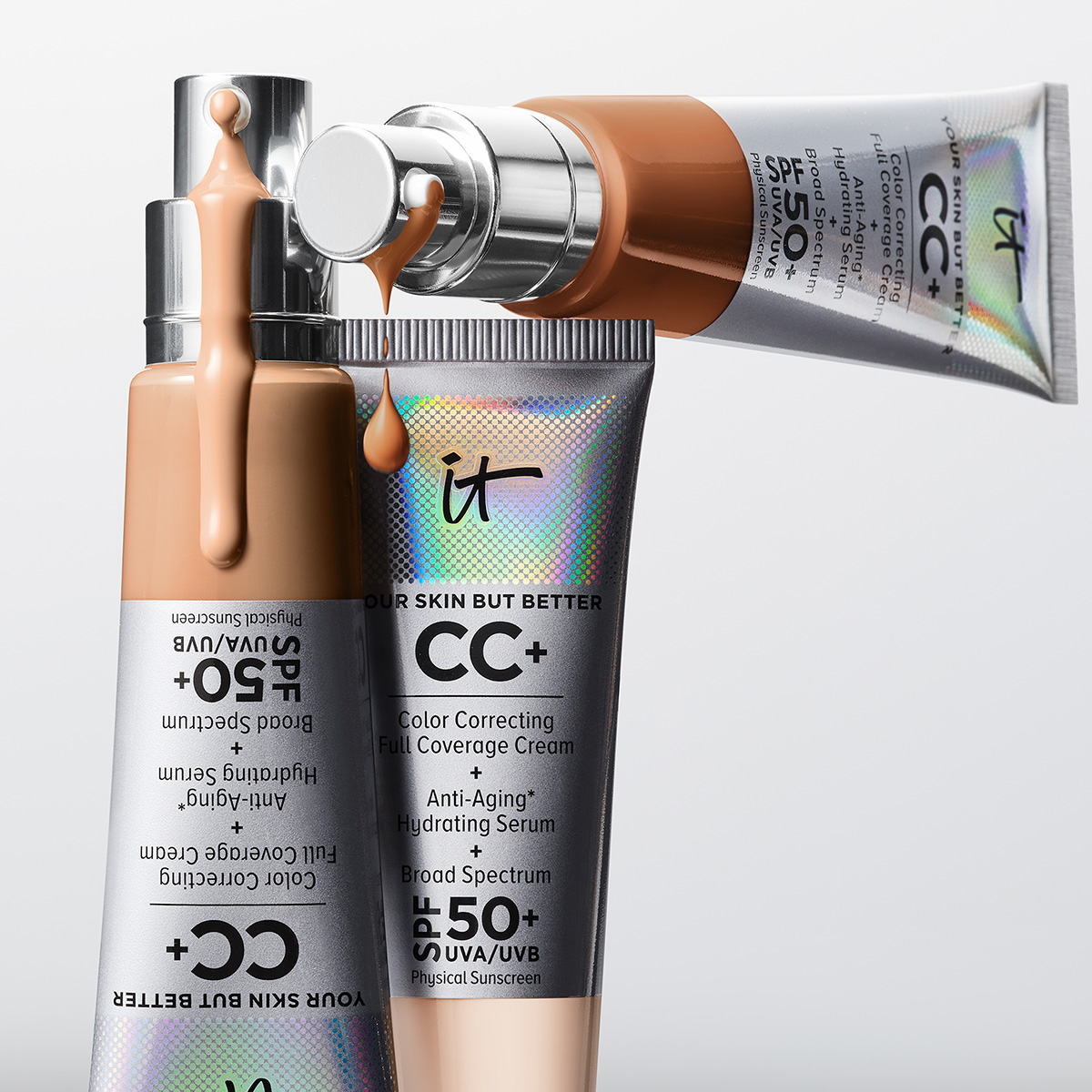 Tre CC-cream-produkter med SPF 50+ i snygga metallförpackningar med CC-cream som droppar från pumparna.