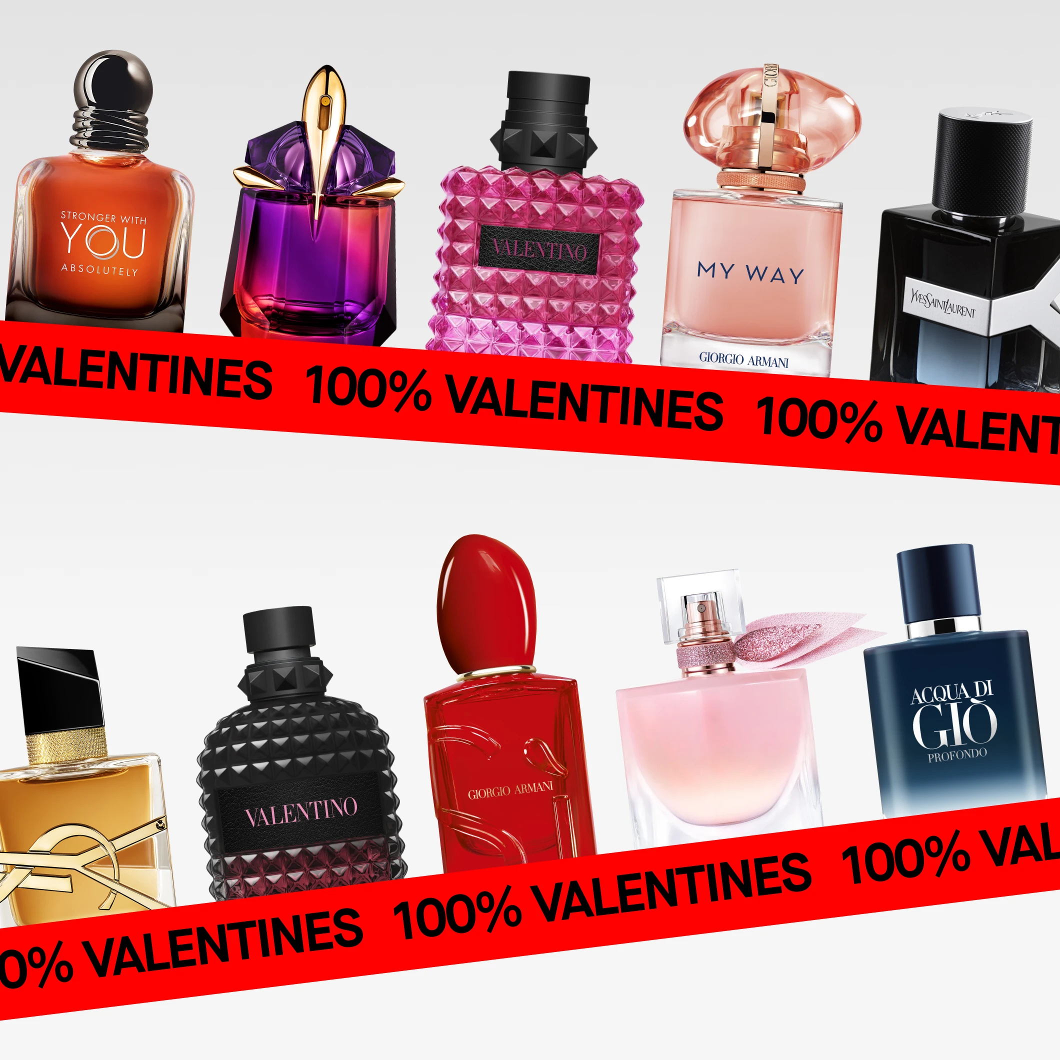 Parfymflaskor från Emporio Armani, Mugler, Valentino, Giorgio Armani och Yves Saint Laurent arrangerade horisontellt mot ljus bakgrund. En röd banderoll med texten ”100% Valentines” täcker nedre delen av bilden.