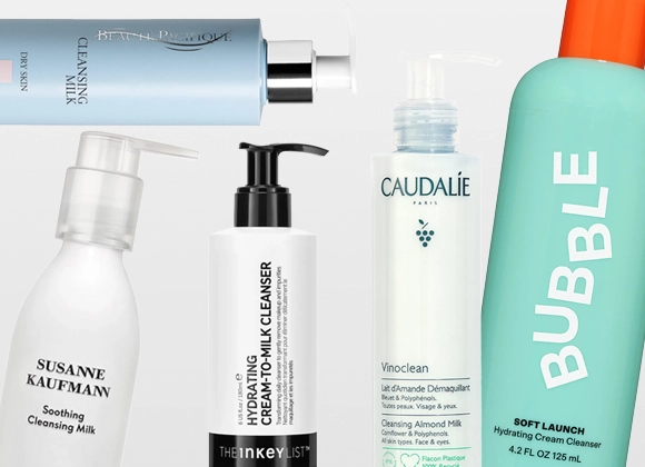Useita ihonhoitotuotteita puhdistusmaidon muodossa merkeiltä Susanne Kaufmann, The Inkey List, Caudalie ja Bubble skincare, pumppupulloissa ja tuubeissa vaaleaa taustaa vasten. Näkyvä teksti sisältää “Soothing Cleansing Milk”, “Oat Cleansing Balm”, “Vinoclean Cleansing Almond Milk” ja “Milky Silky Calming Cleansing Lotion”.