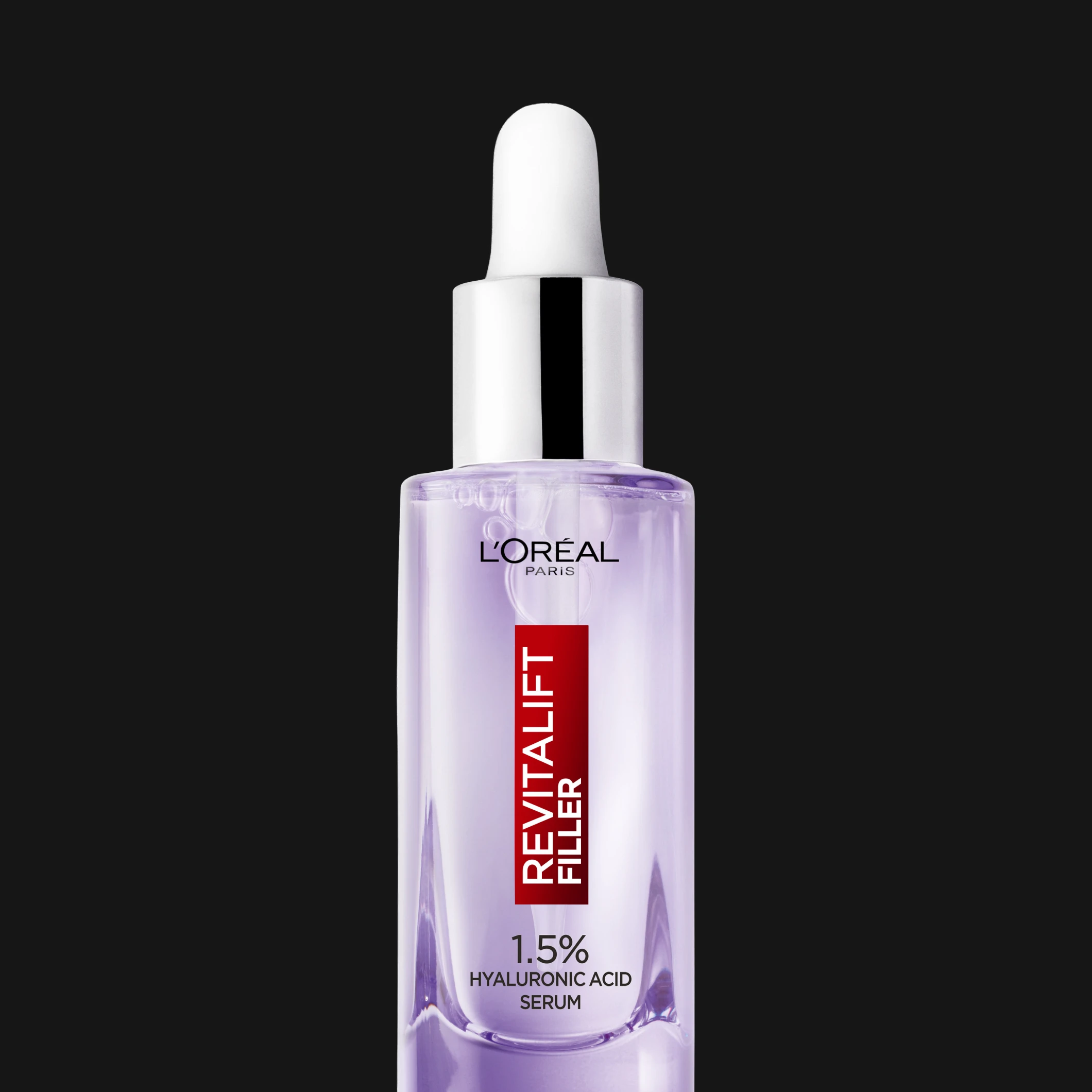 L’Oréal Paris Revitalift Filler 1.5% Hyaluronic Acid Serum i transparent lila flaska med pipett mot svart bakgrund.