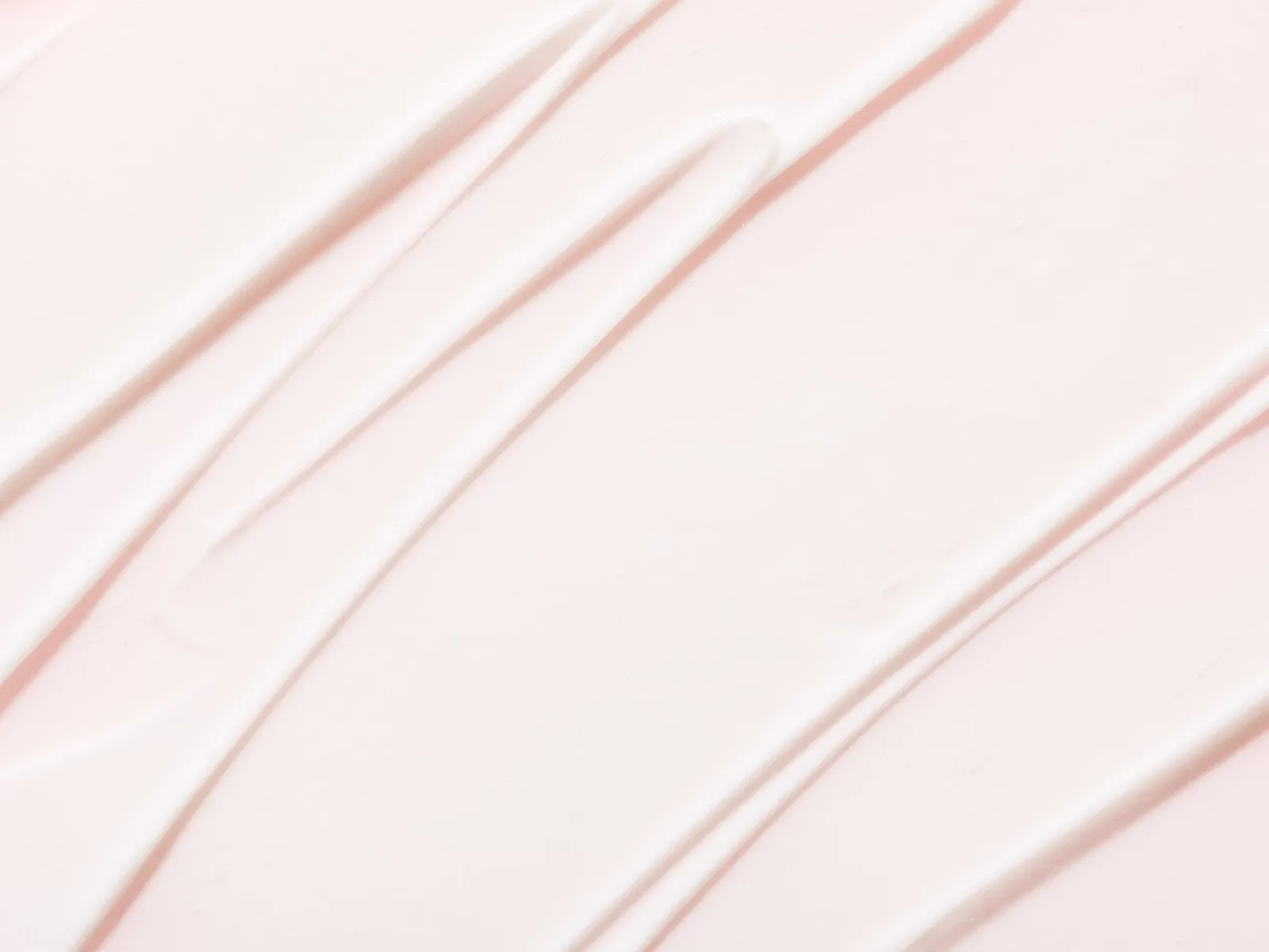 Tekstur bilde av en lys rosa krem