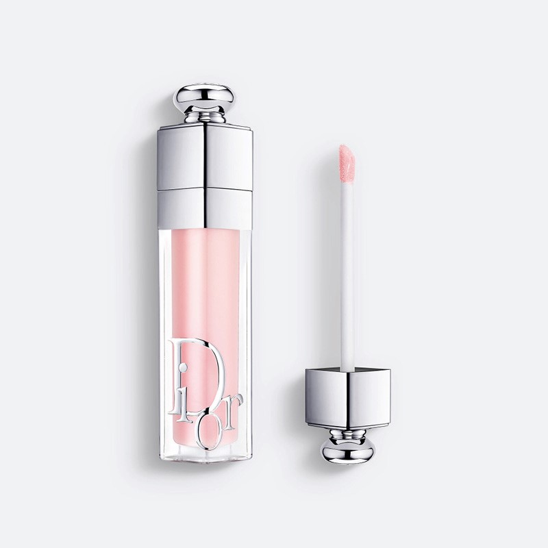 Dior Addict Lip Glow Oil i ljusrosa nyans, med flaska och applikator mot vit bakgrund.
